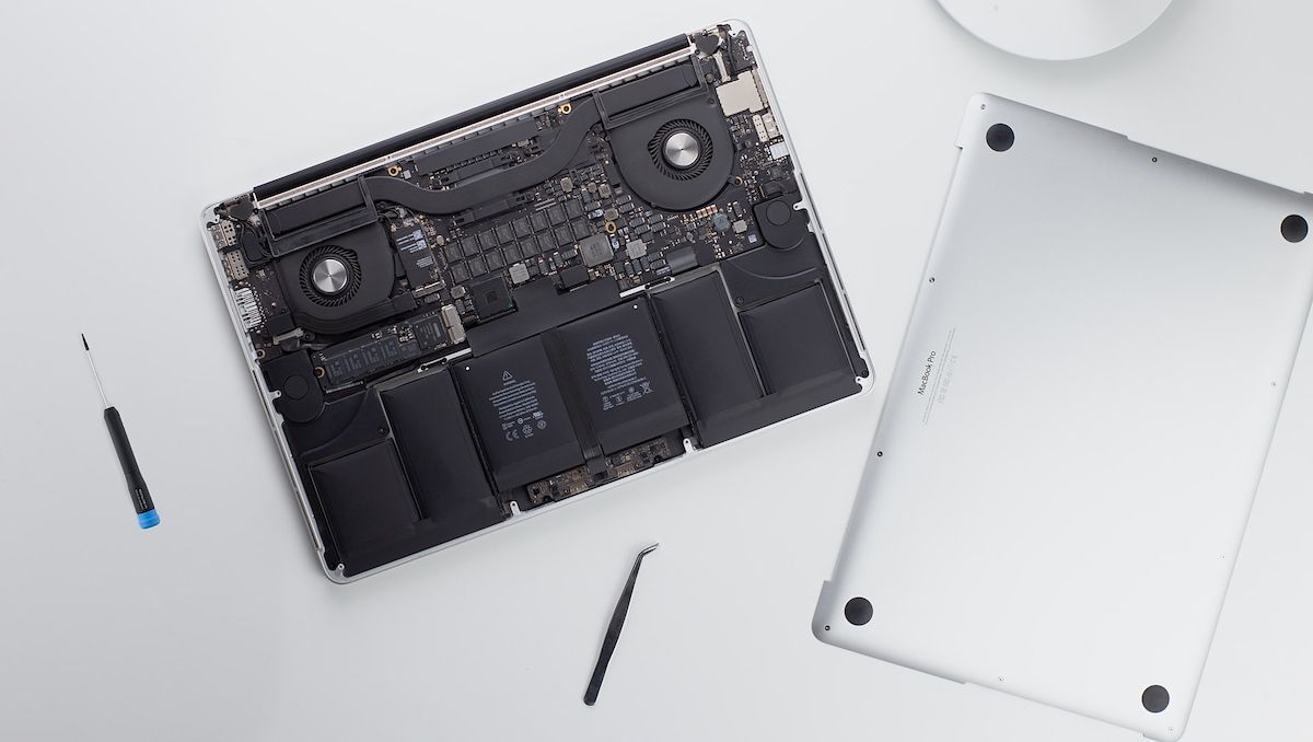 A macbook pro with its back panel opened 