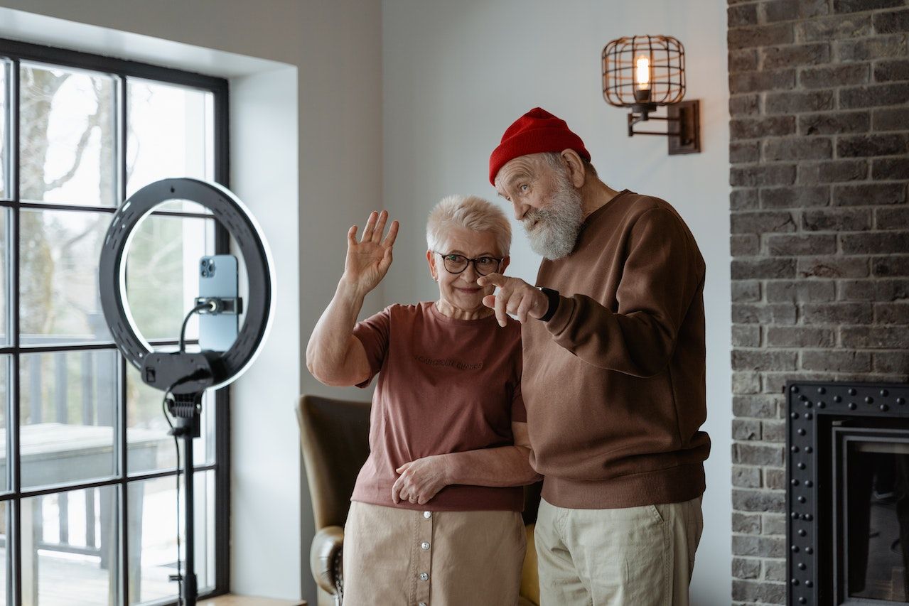 Man in Brown Long Sleeve Shirt Standing Beside a Woman in Brown Shirt